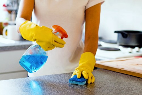 Carpet cleaning technician in W10 preparing equipment with safety focus